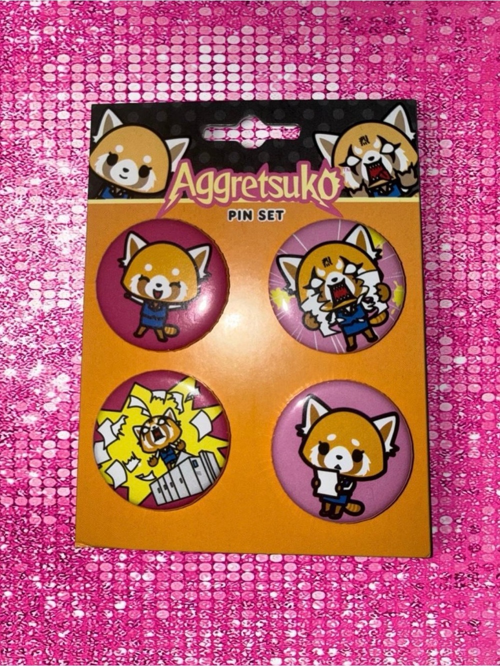 Aggretsuko pin set with four different red panda characters in various poses